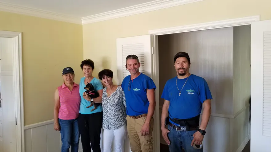The Moving Pro Inc crew with a happy family on moving day